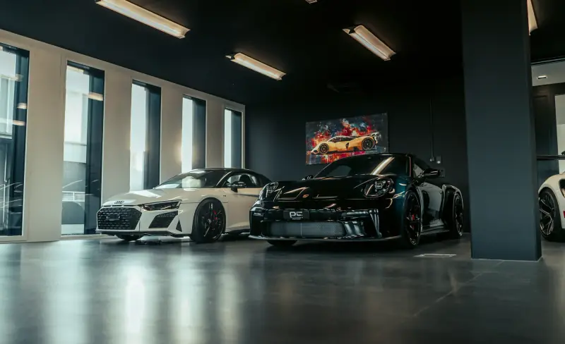 Showroom in the Black Office Widnau with Audi R8 and Porsche