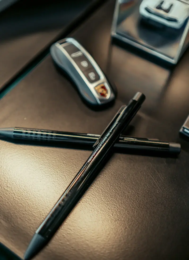 Pen and car key on the leather table