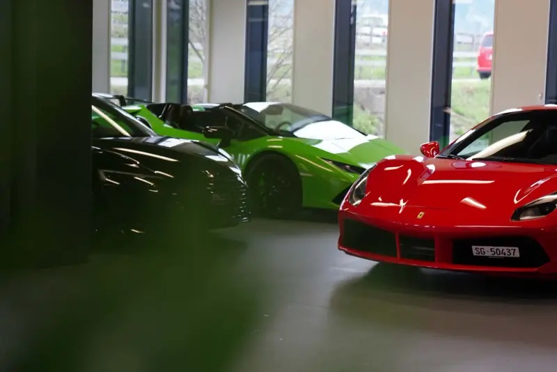 Green Lamborghini and red Ferrari in the showroom