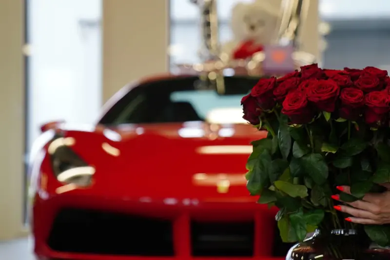 Red Ferrari with a bouquet of roses