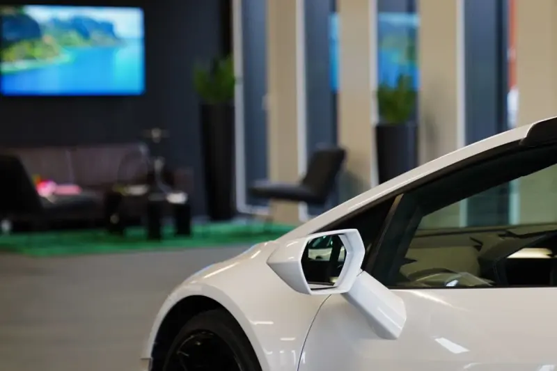 Lounge with a white Lamborghini in the foreground